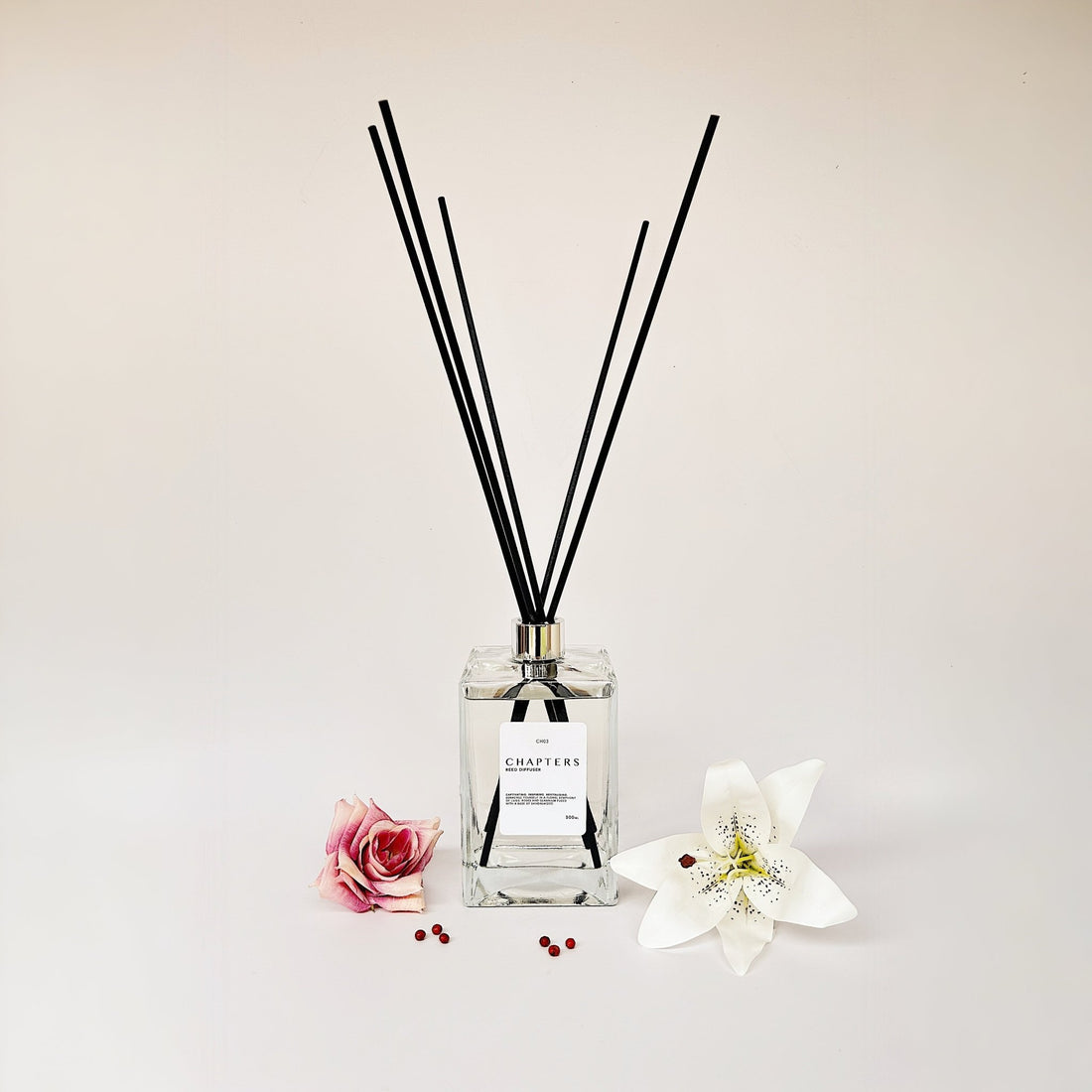 CH03 Deluxe Reed Diffuser with black reeds and floral decor on white background
