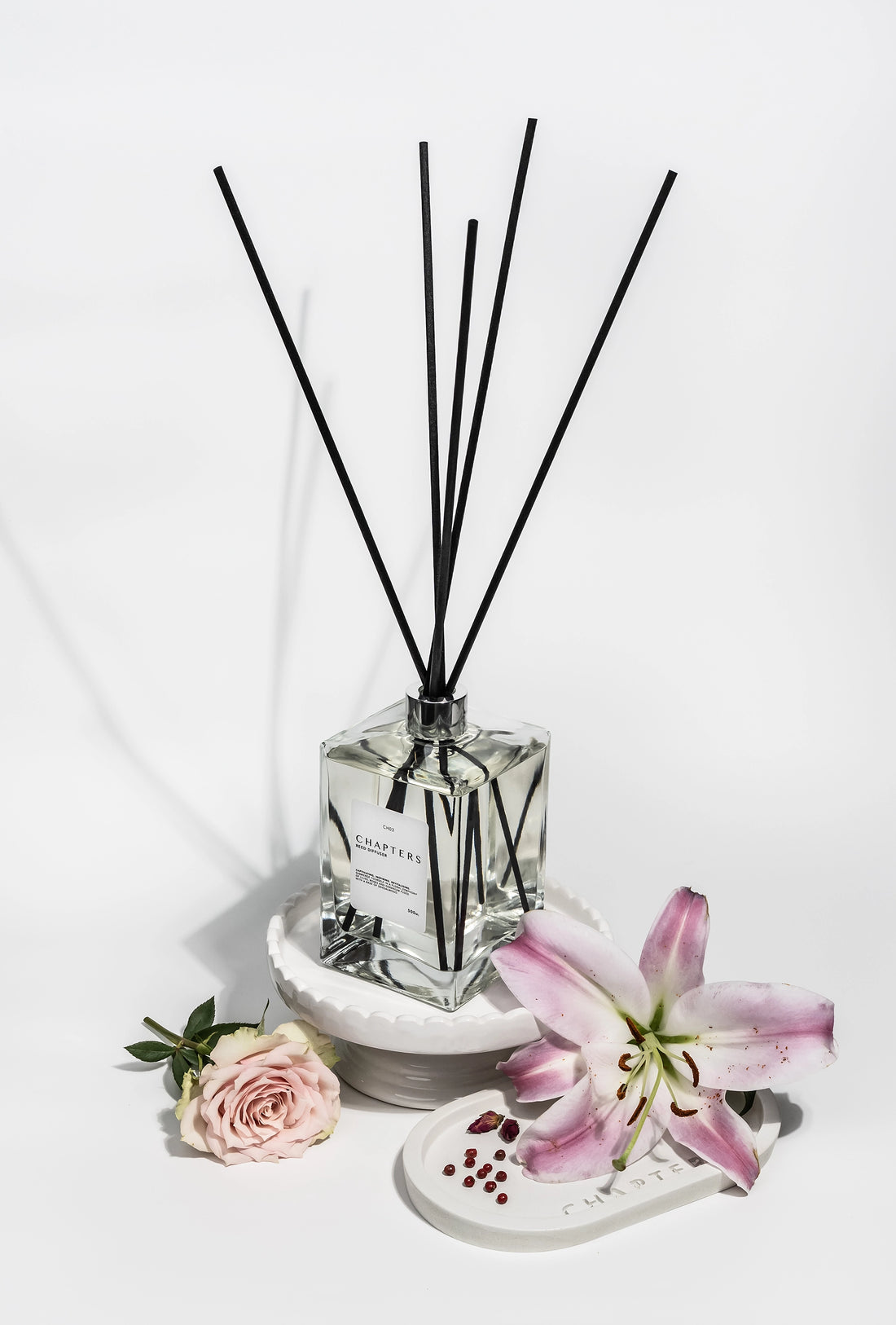 CH03 Deluxe Reed Diffuser with black reeds and floral decor on white background