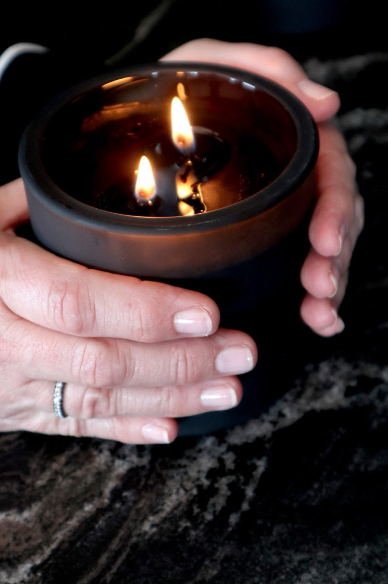 A Chapter 07 candle held in two hands